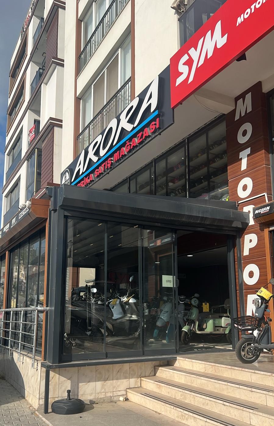Motorport Arora & SYM showroom storefront on Turgut Özal Boulevard, Kuşadası