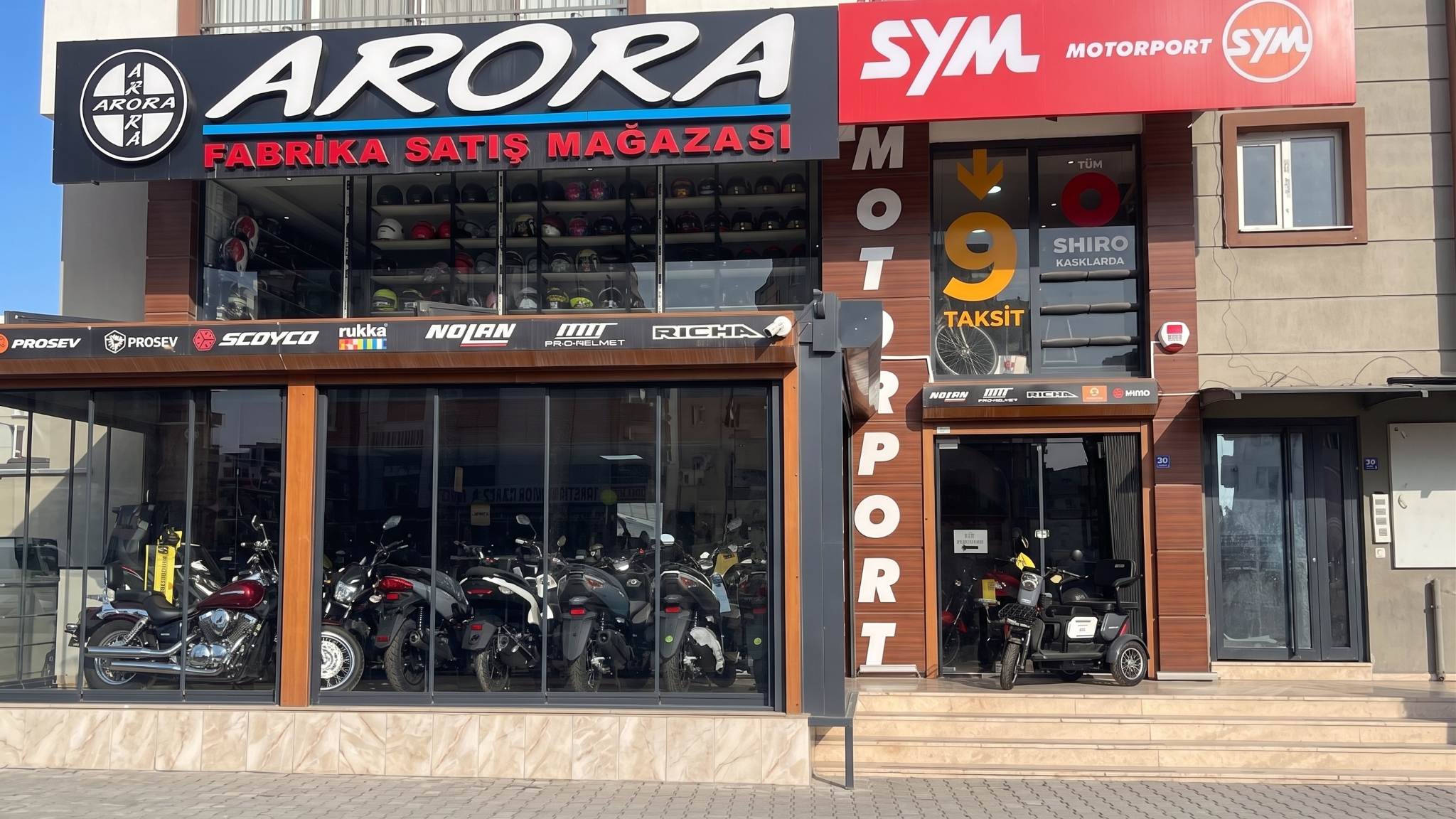 Arora factory sales store side view with scooters in Kuşadası